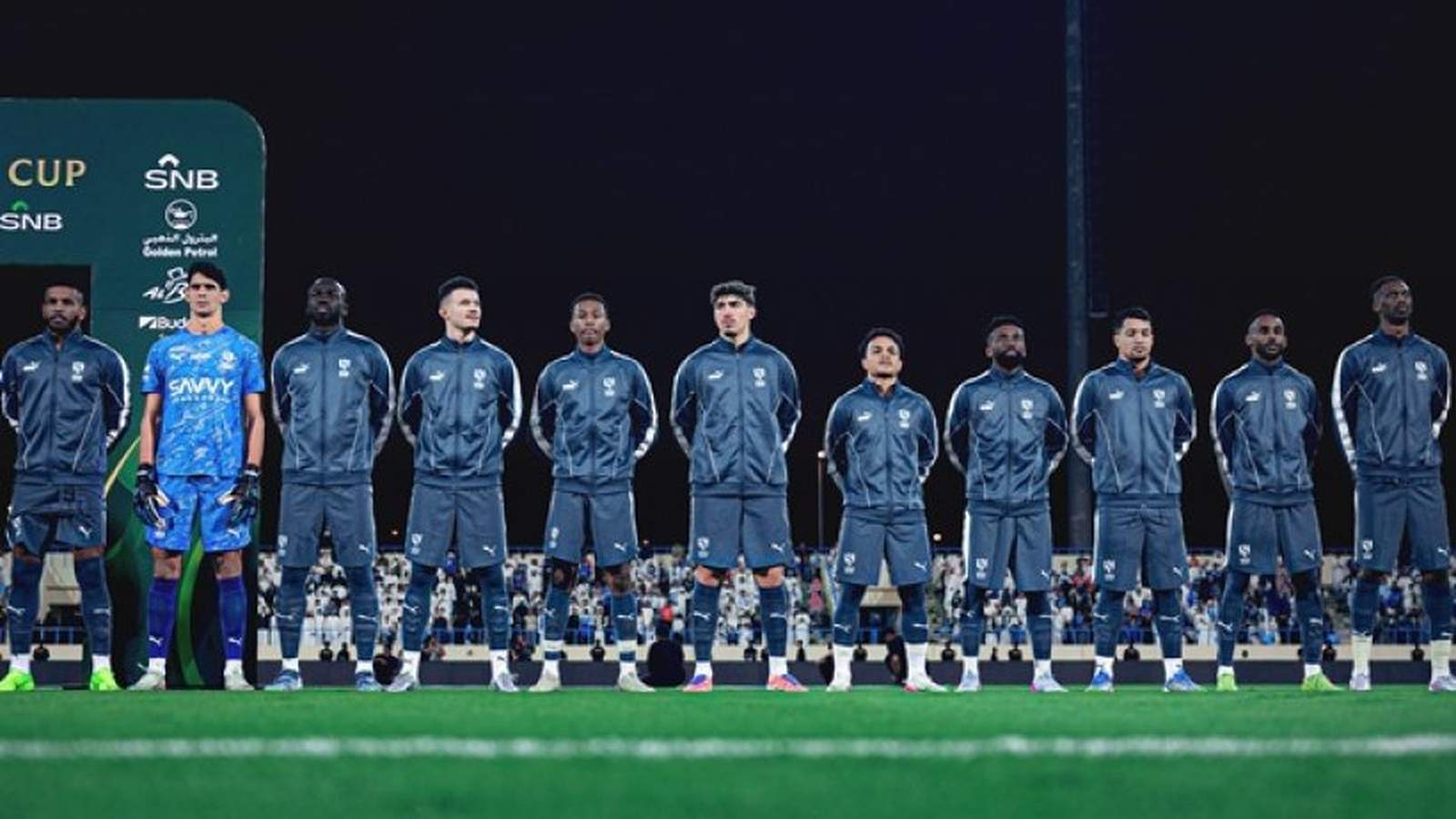 Al-Hilal and Al-Kholood football players on pitch