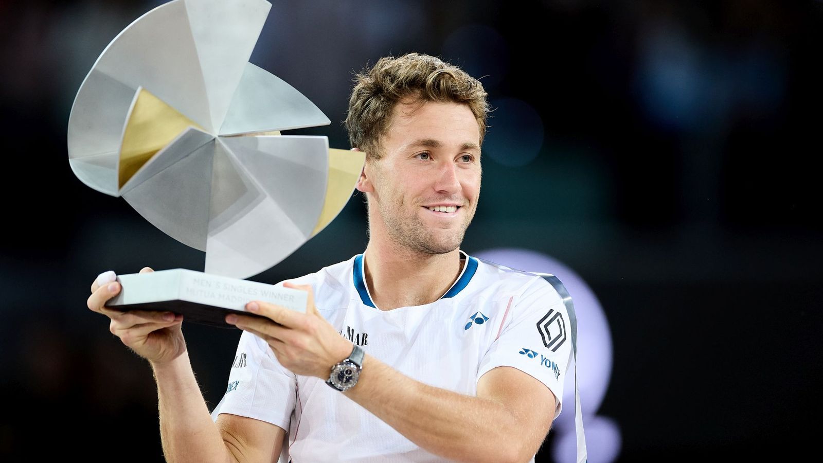 Casper Ruud holding tennis trophy