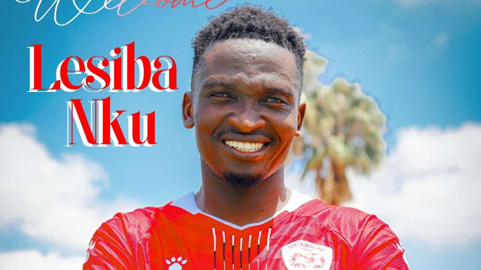 Soccer players contesting for the ball on a green pitch