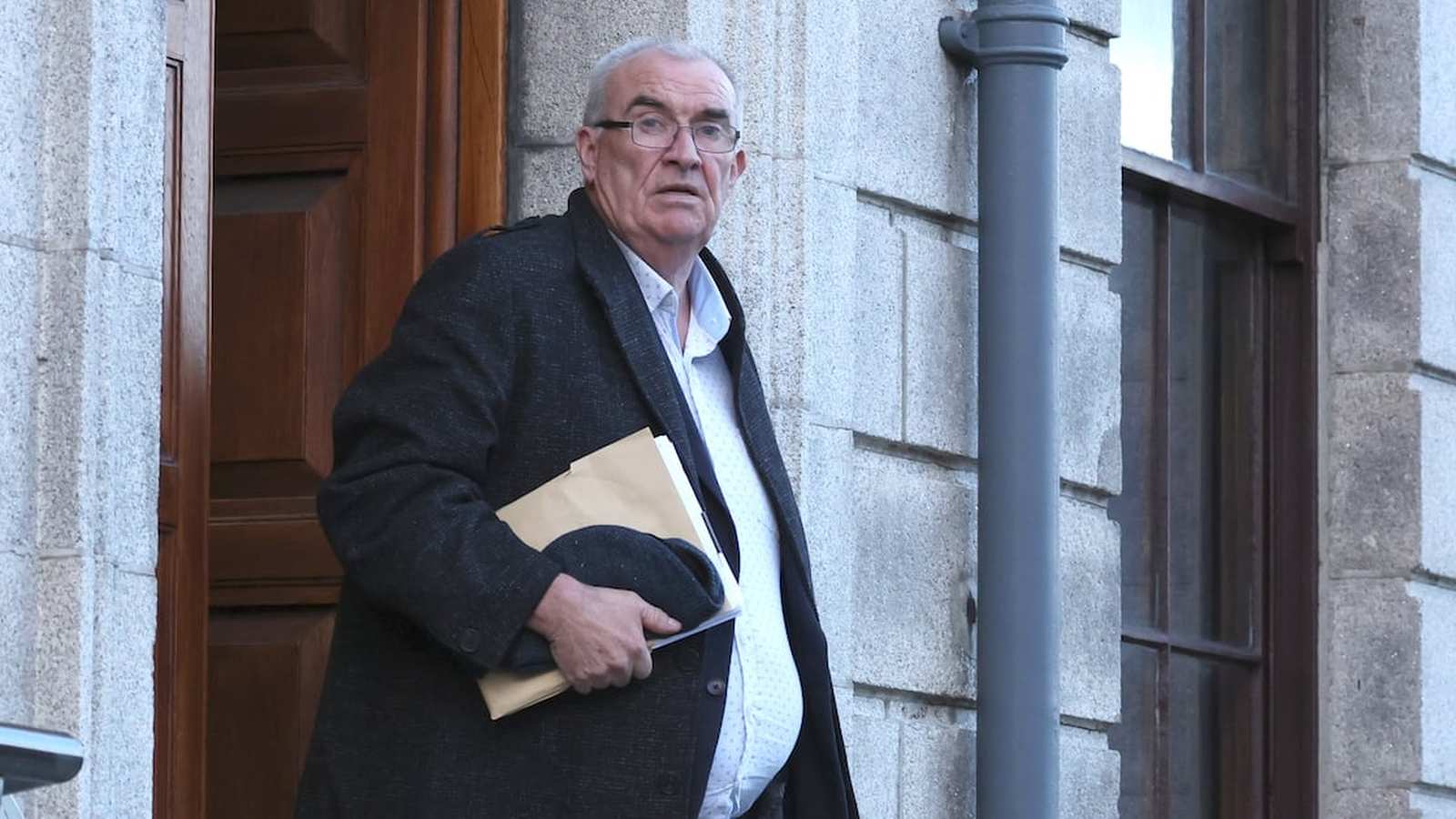 Man leaving courthouse, legal setting