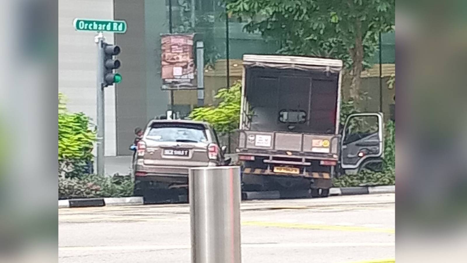 Damaged lorry and car on pavement