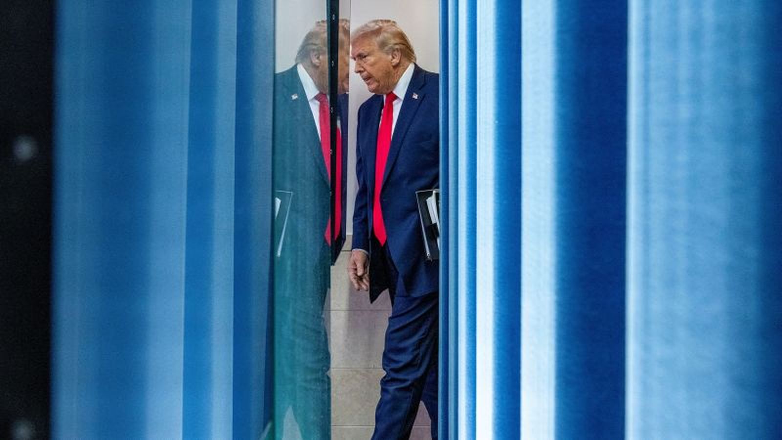 President Donald Trump speaking at podium