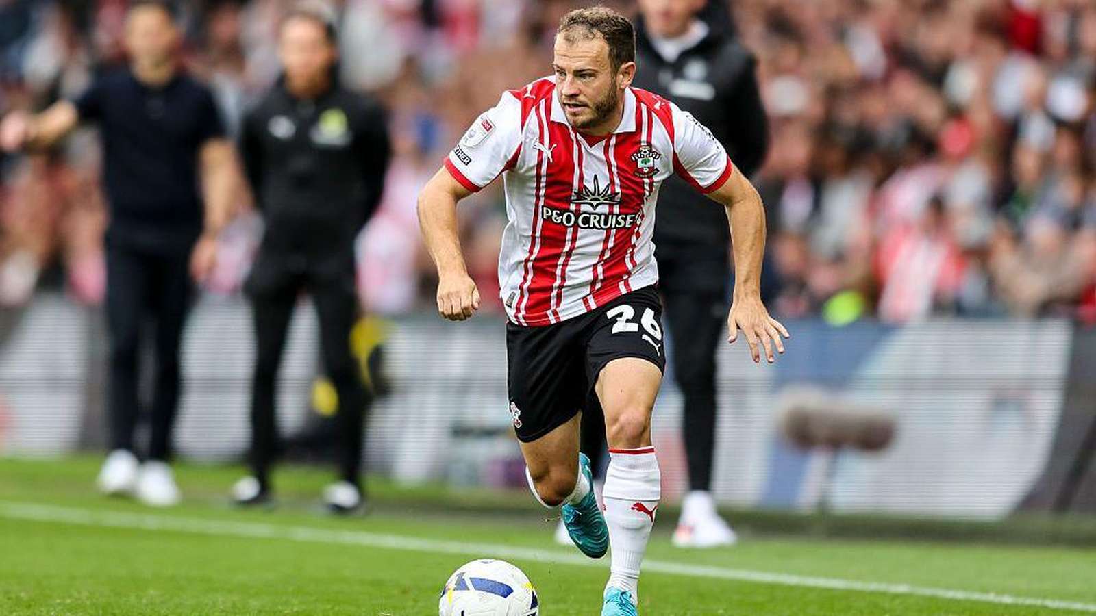 Ryan Fraser celebrating a goal on a football pitch