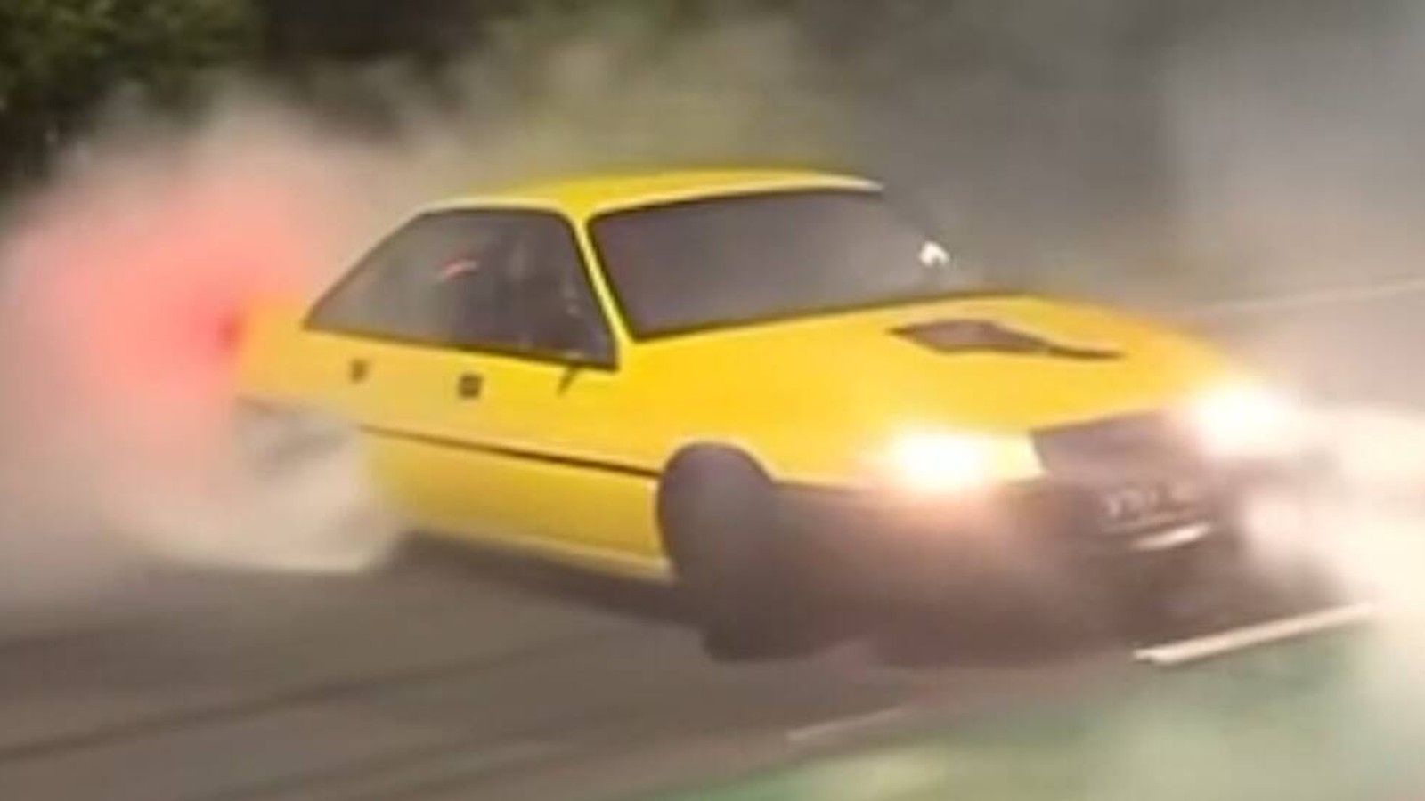 Yellow Holden Commodore burnout smoke