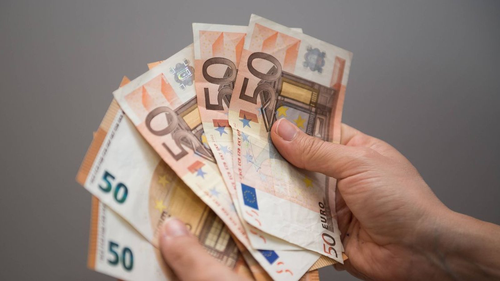 Hand holding Euro coins in Ireland