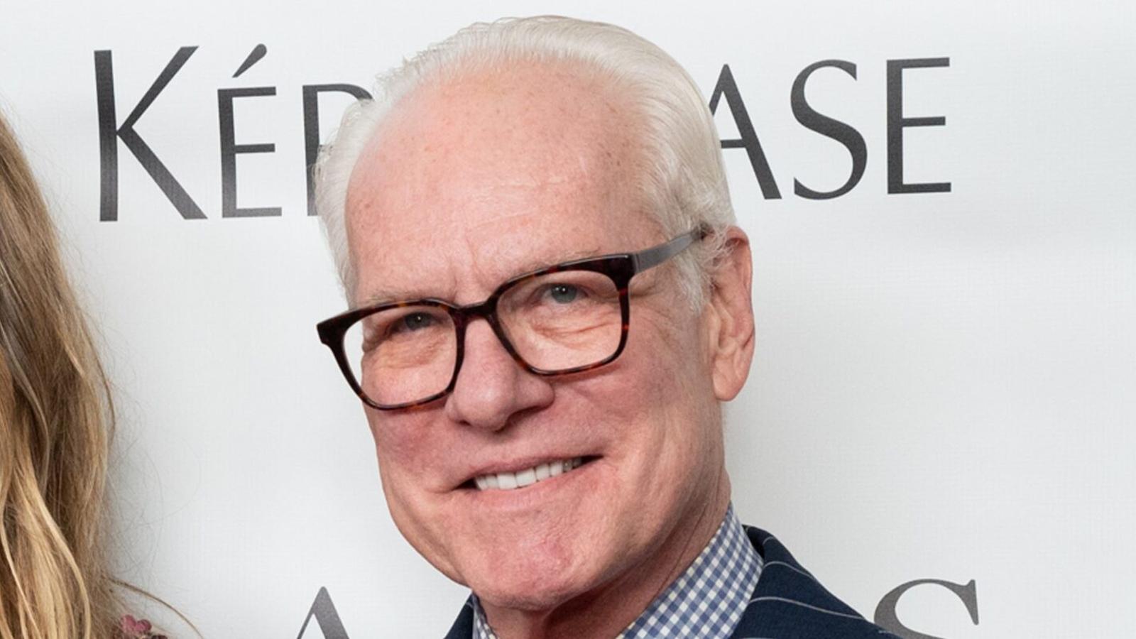 Tim Gunn smiling on a red carpet