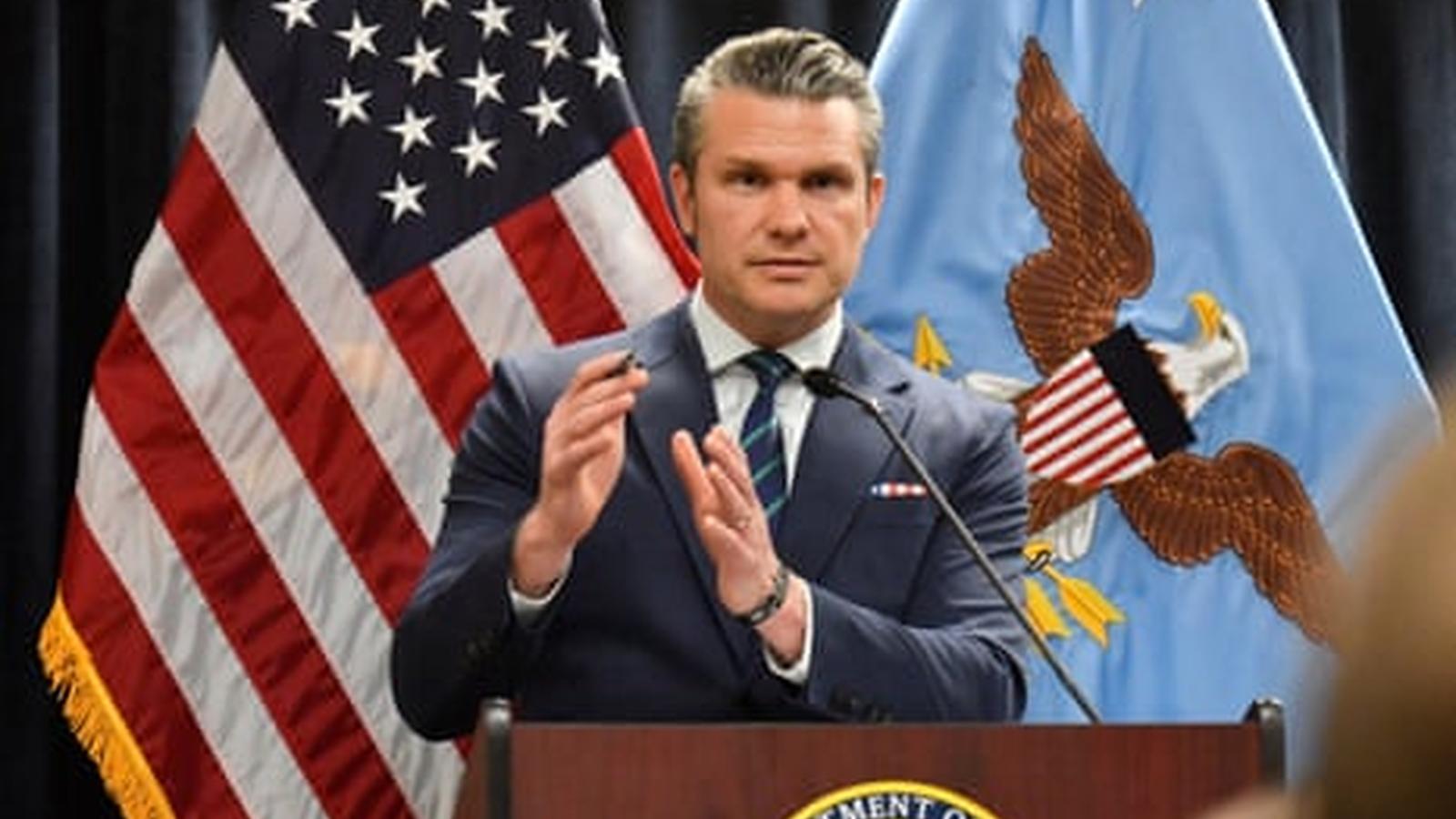 Defense Secretary Pete Hegseth speaking at a podium