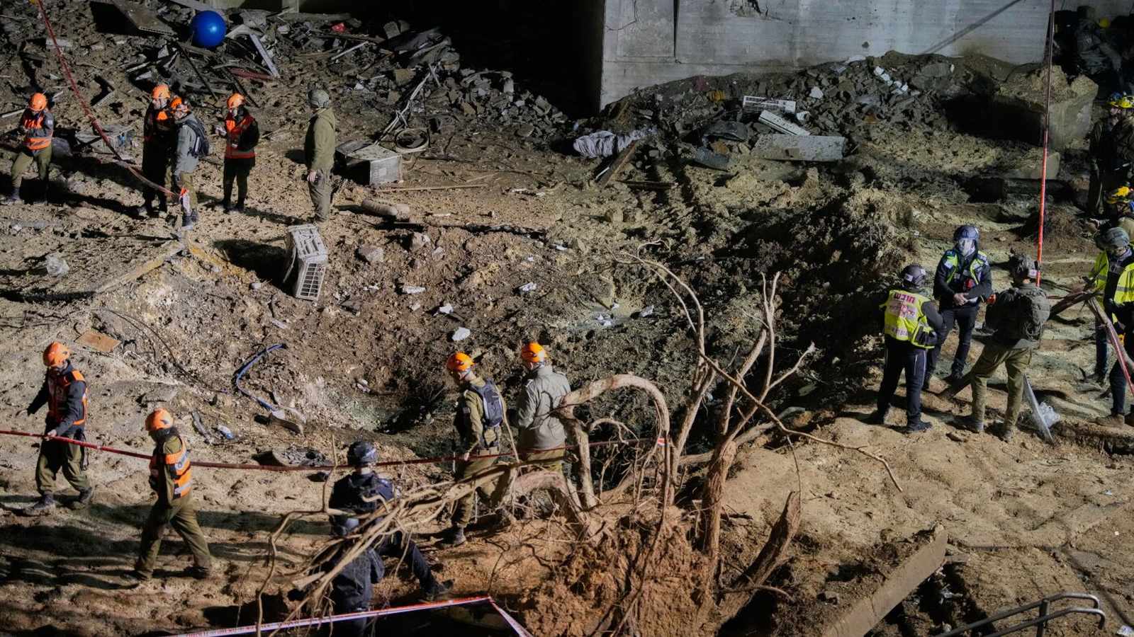 Destroyed buildings and craters in Arad after missile impact