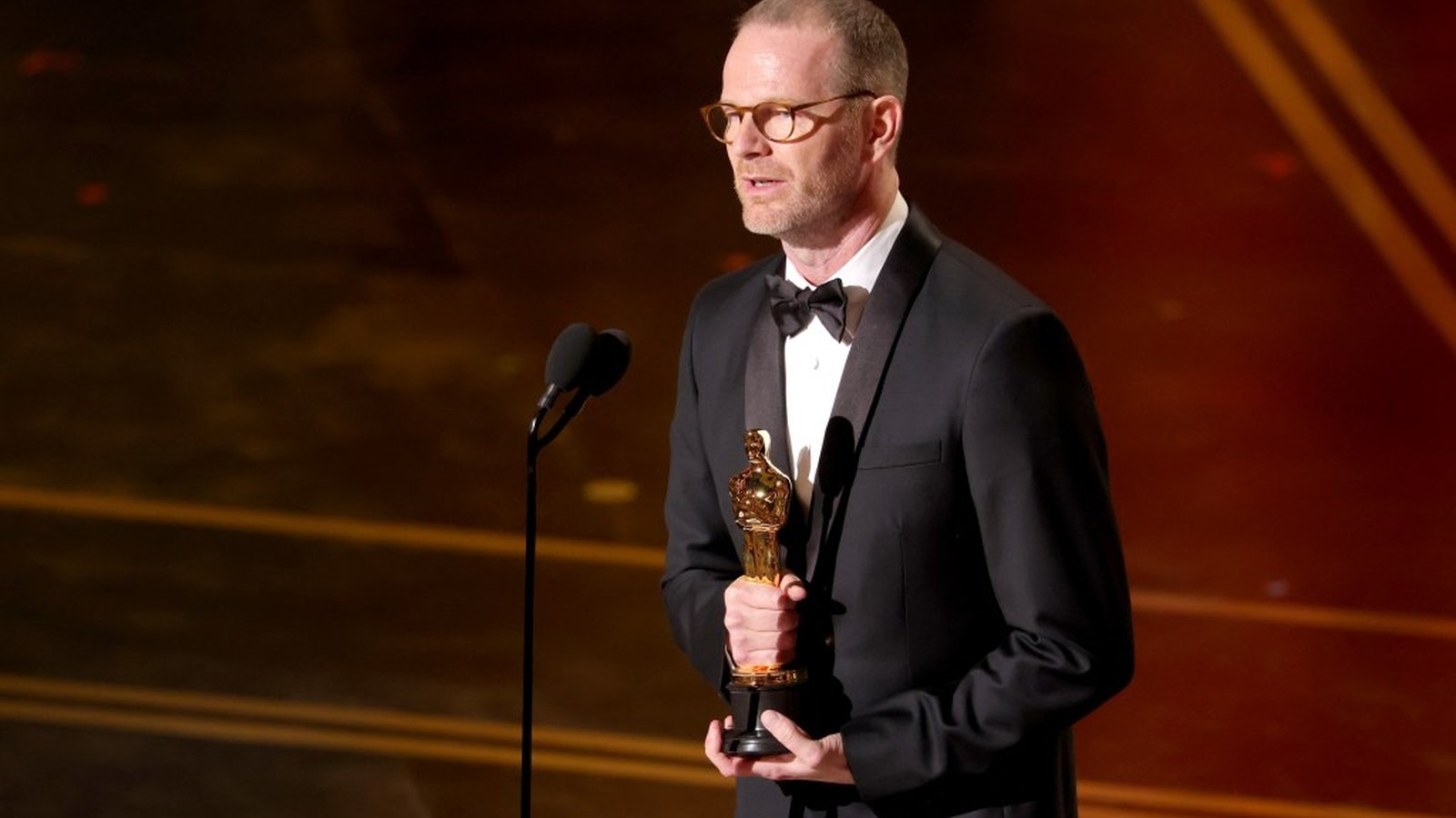 Joachim Trier holding Oscar trophy