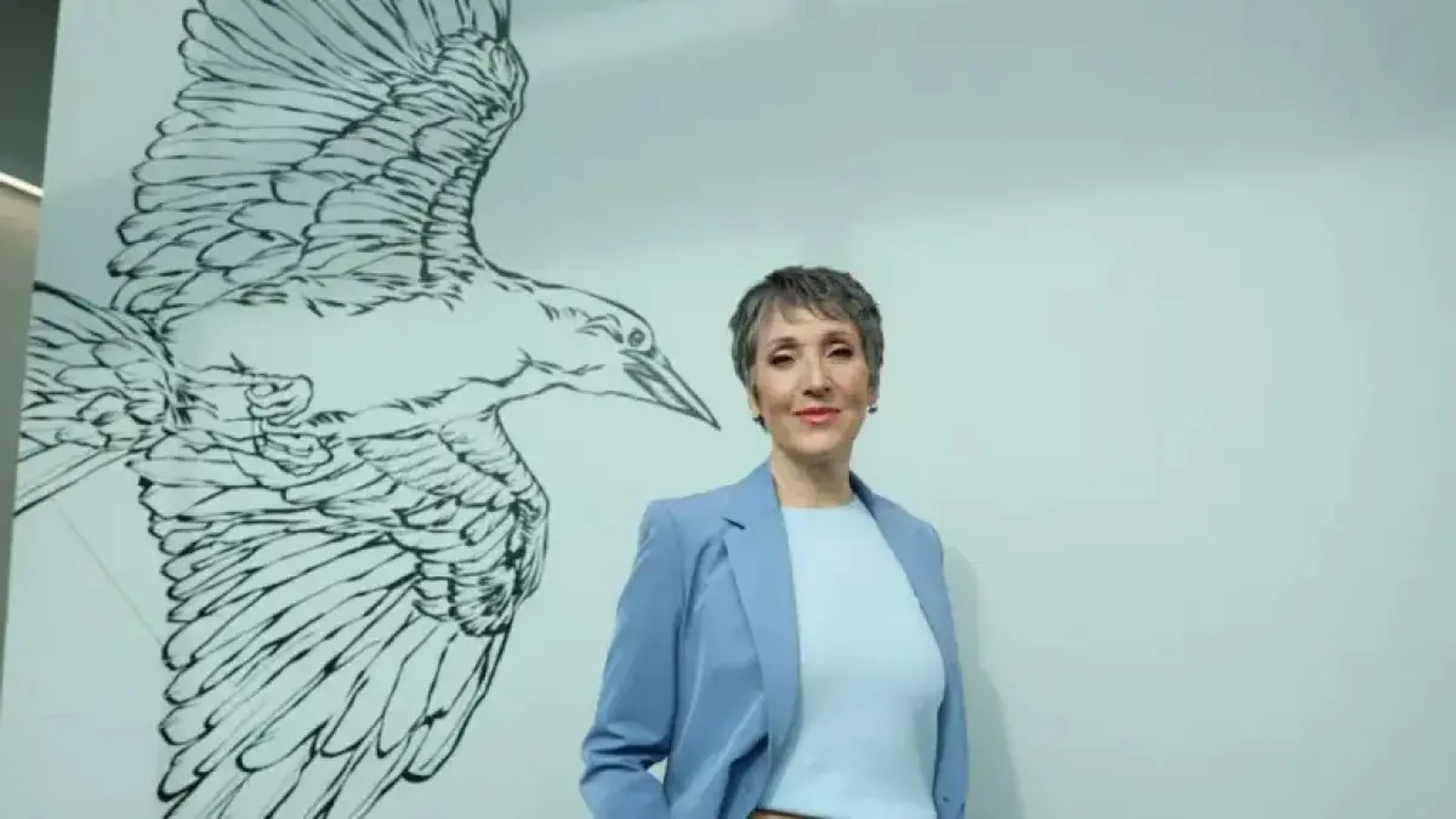 Julie Drolet at news anchor desk