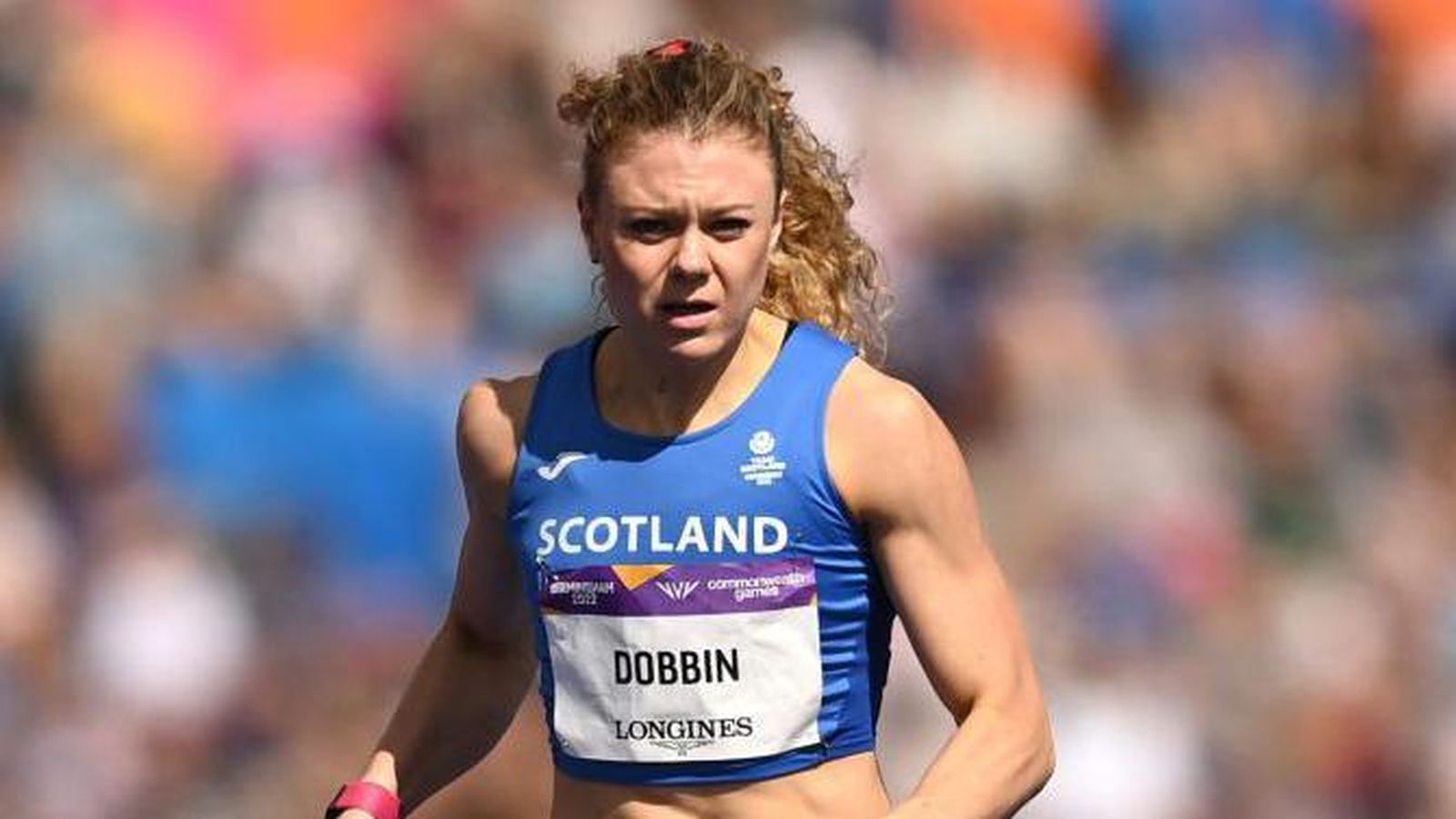 Scottish sprinter Beth Dobbin wearing a blue Scotland jersey during a track race