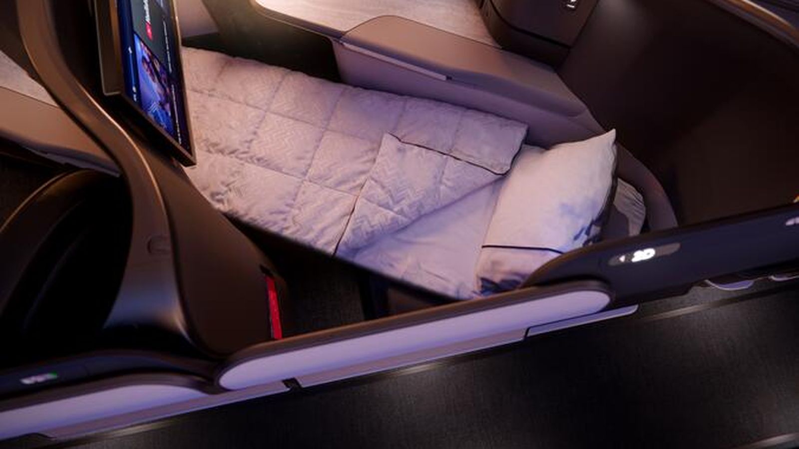 Overhead view of a modern Delta One business class suite with lie-flat bed