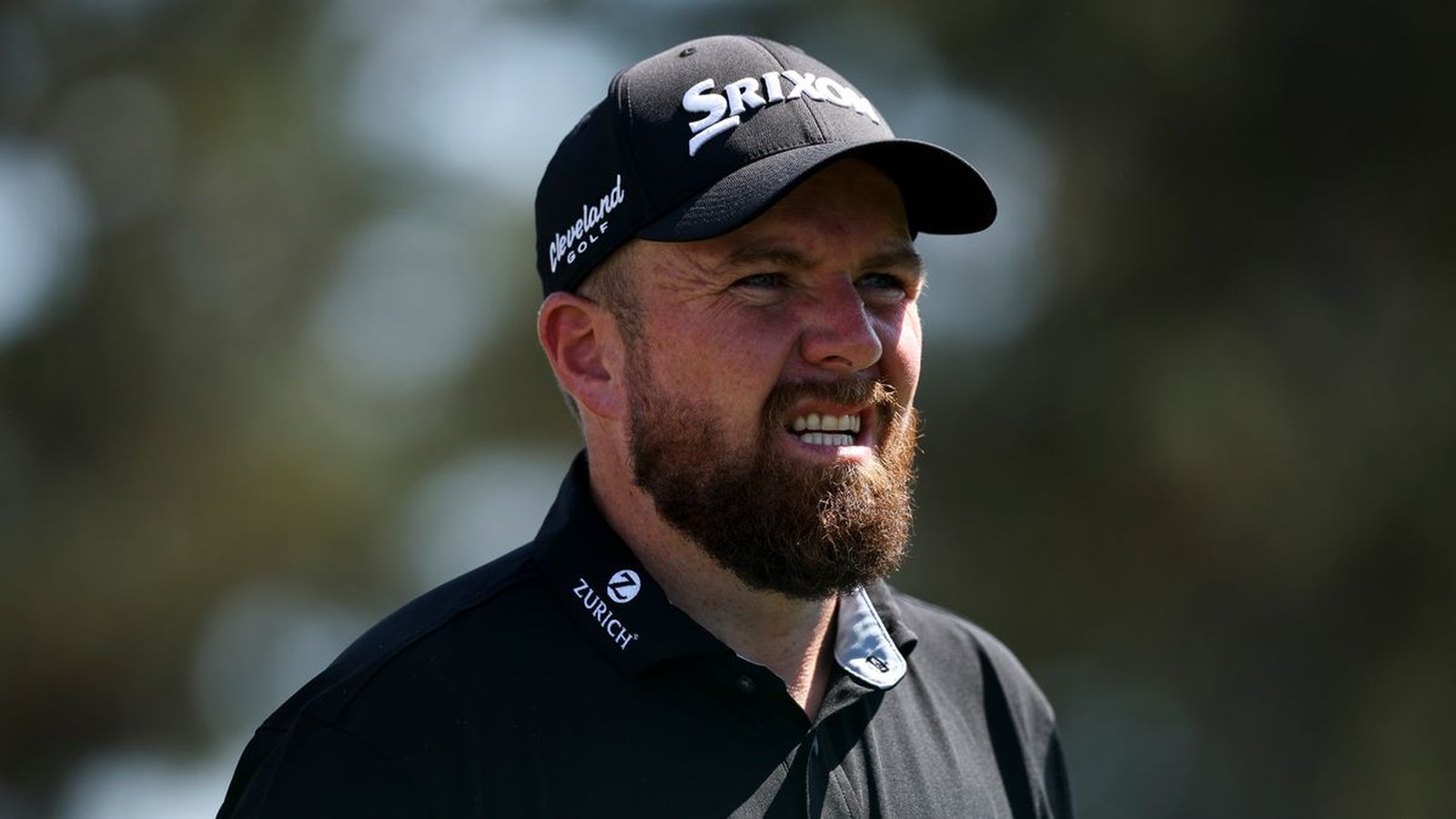 Professional golfer Shane Lowry wearing a black cap and shirt at Augusta National