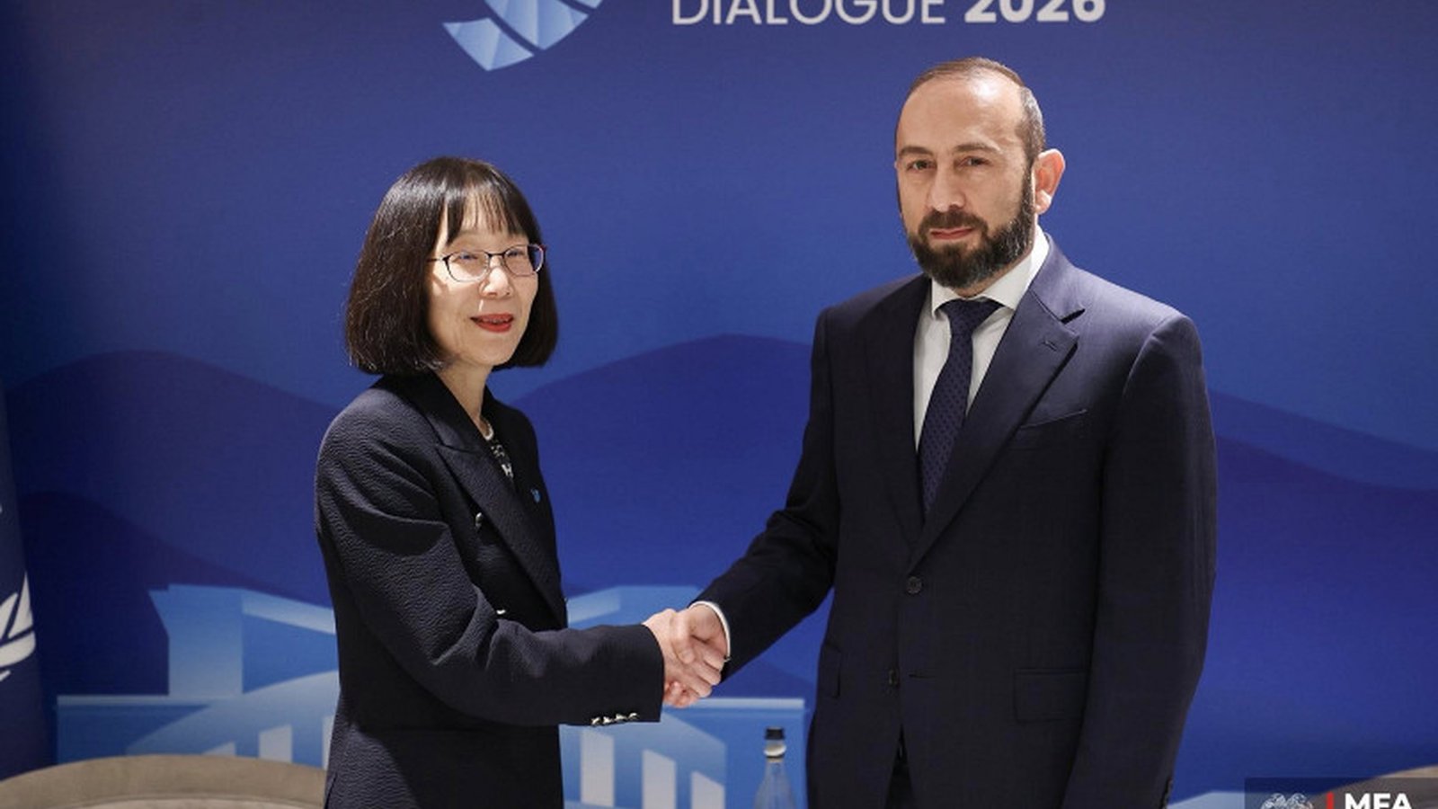 Armenian Foreign Minister Ararat Mirzoyan shakes hands with ICC President Tomoko Akane in Yerevan