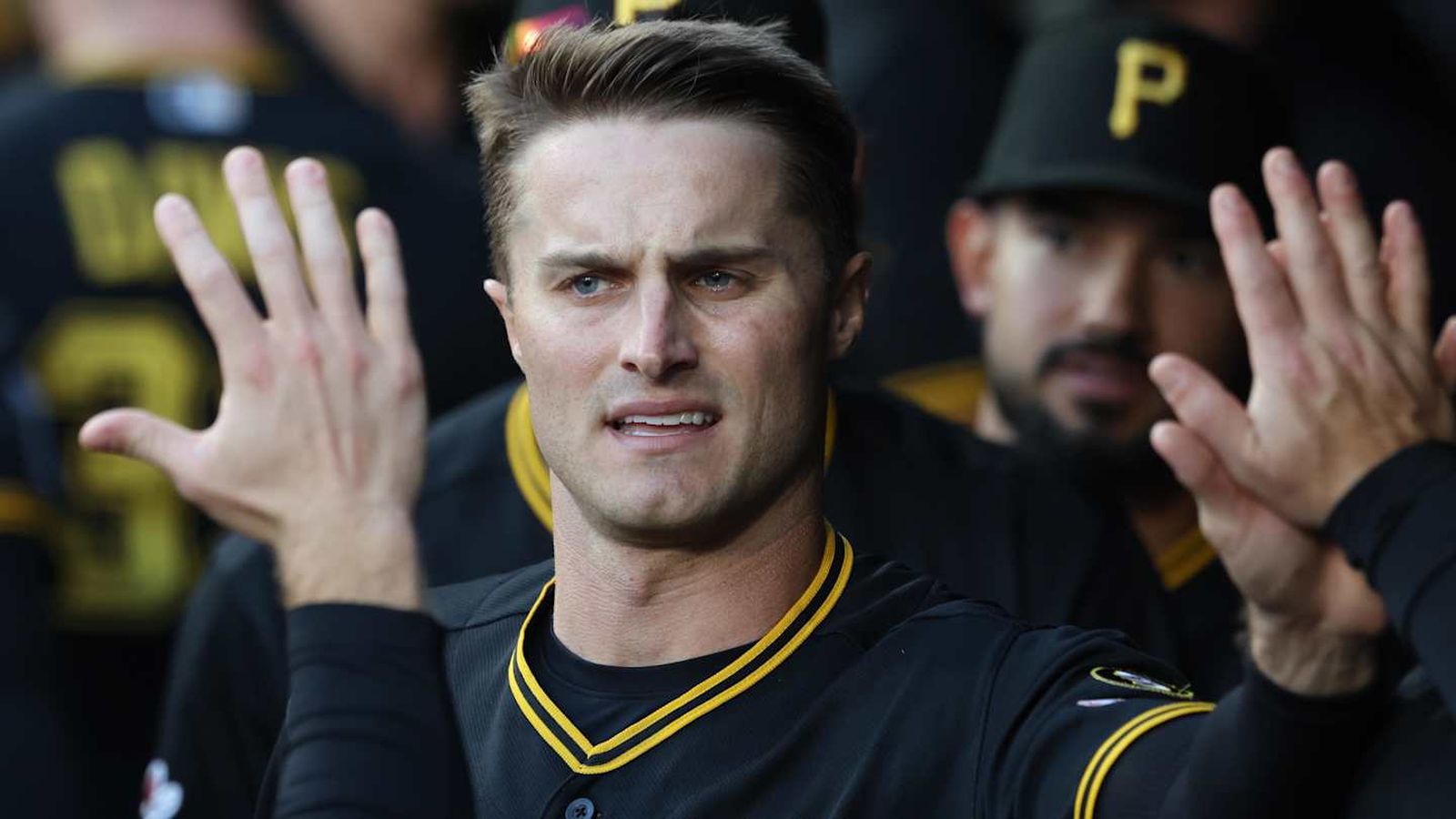 Chris Devenski, a baseball player in a black and yellow Pittsburgh Pirates uniform, looks forward wi