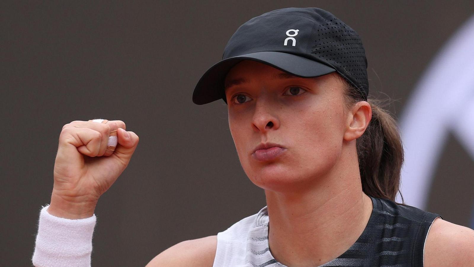 Iga Swiatek clenches her fist in celebration during a tennis match in Rome