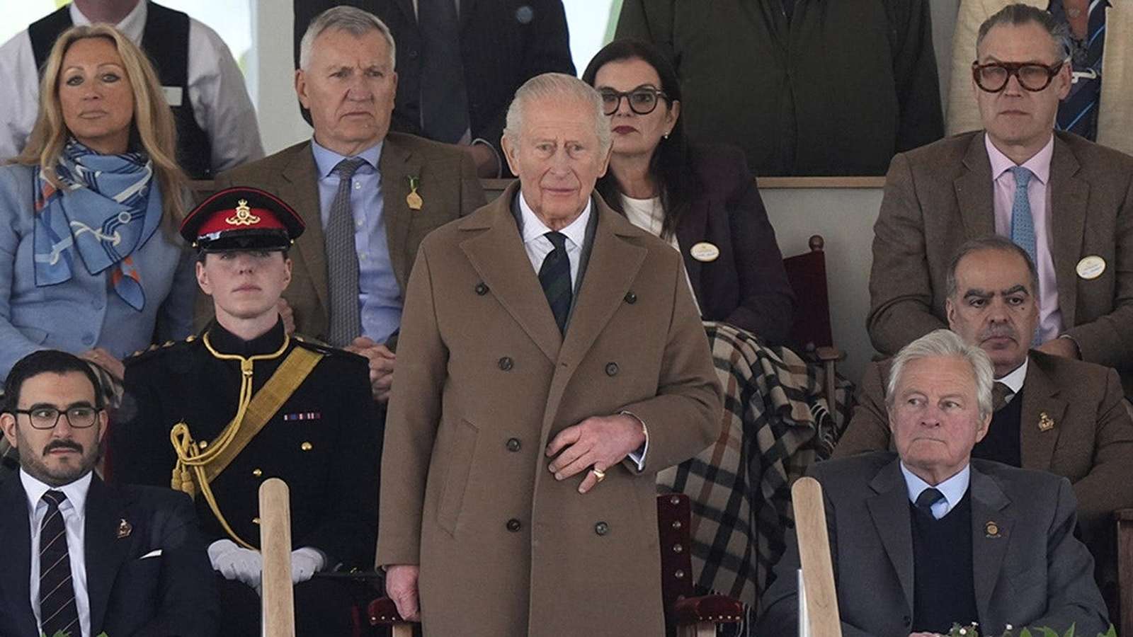 King Charles III standing in a crowd at the Royal Windsor Horse Show event