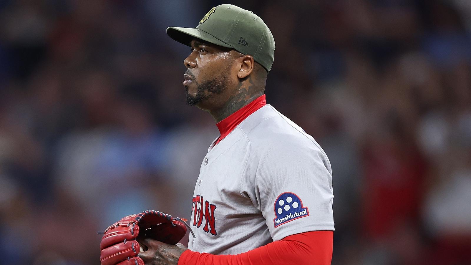 Boston Red Sox relief pitcher Aroldis Chapman wearing a green cap and grey jersey