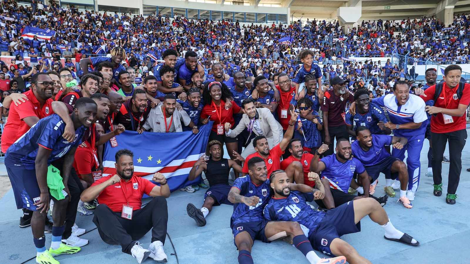 Cape Verde national football team players and staff celebrating on the pitch together
