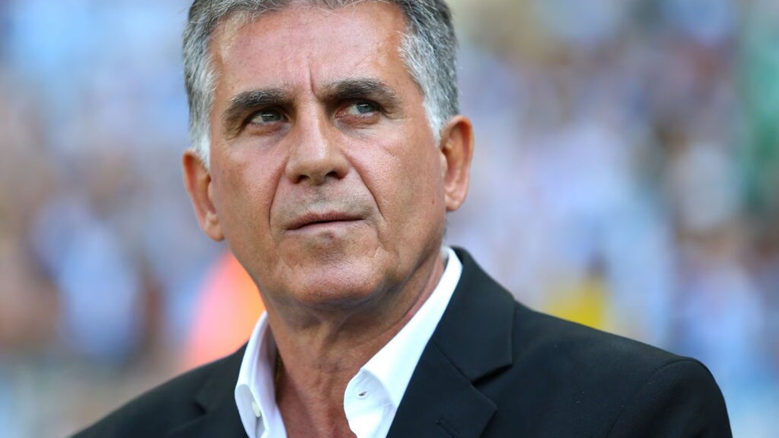 Close up portrait of football manager Carlos Queiroz wearing a black suit jacket