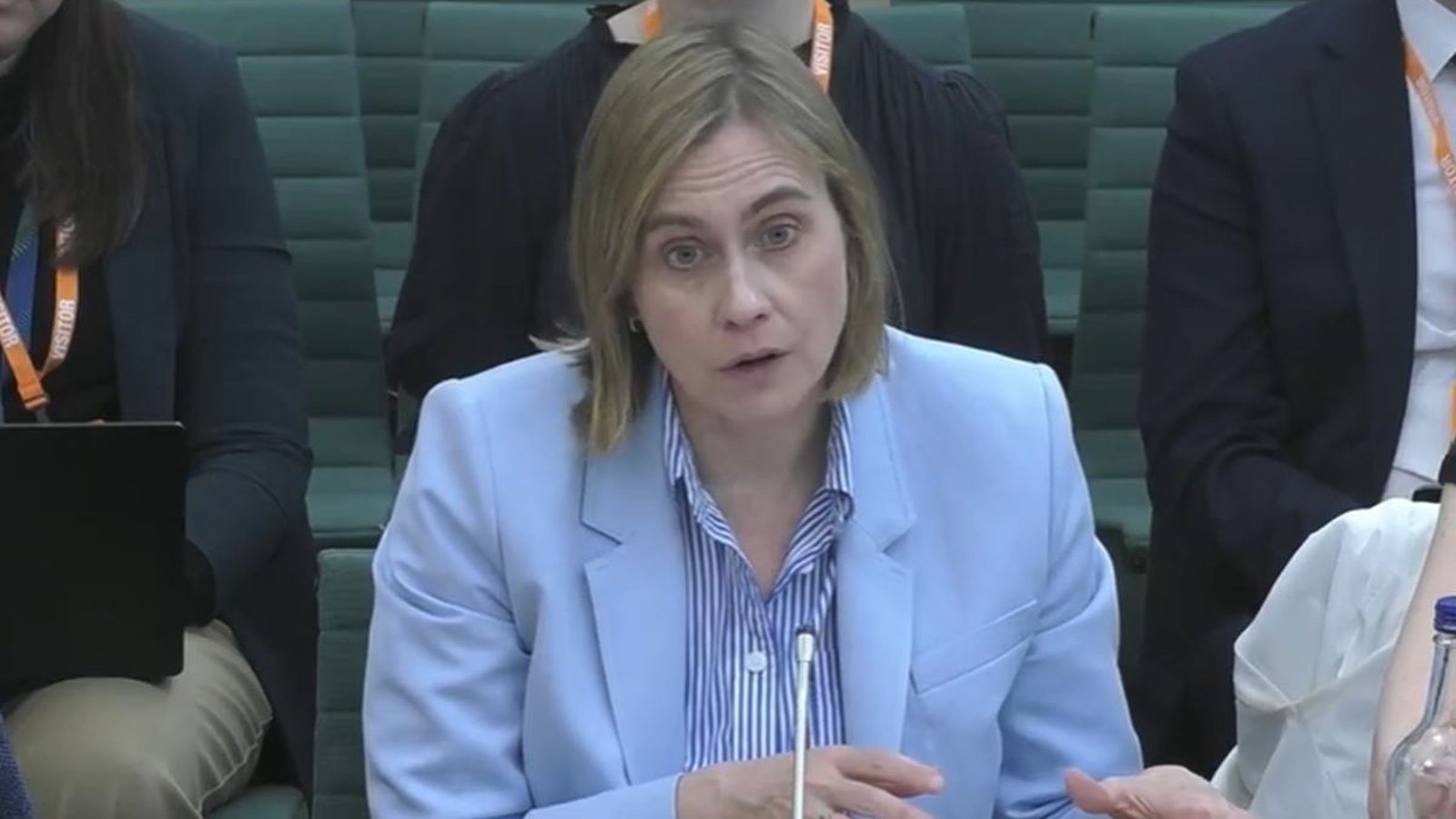 Dame Sarah Healey wearing a light blue blazer speaking at a committee hearing