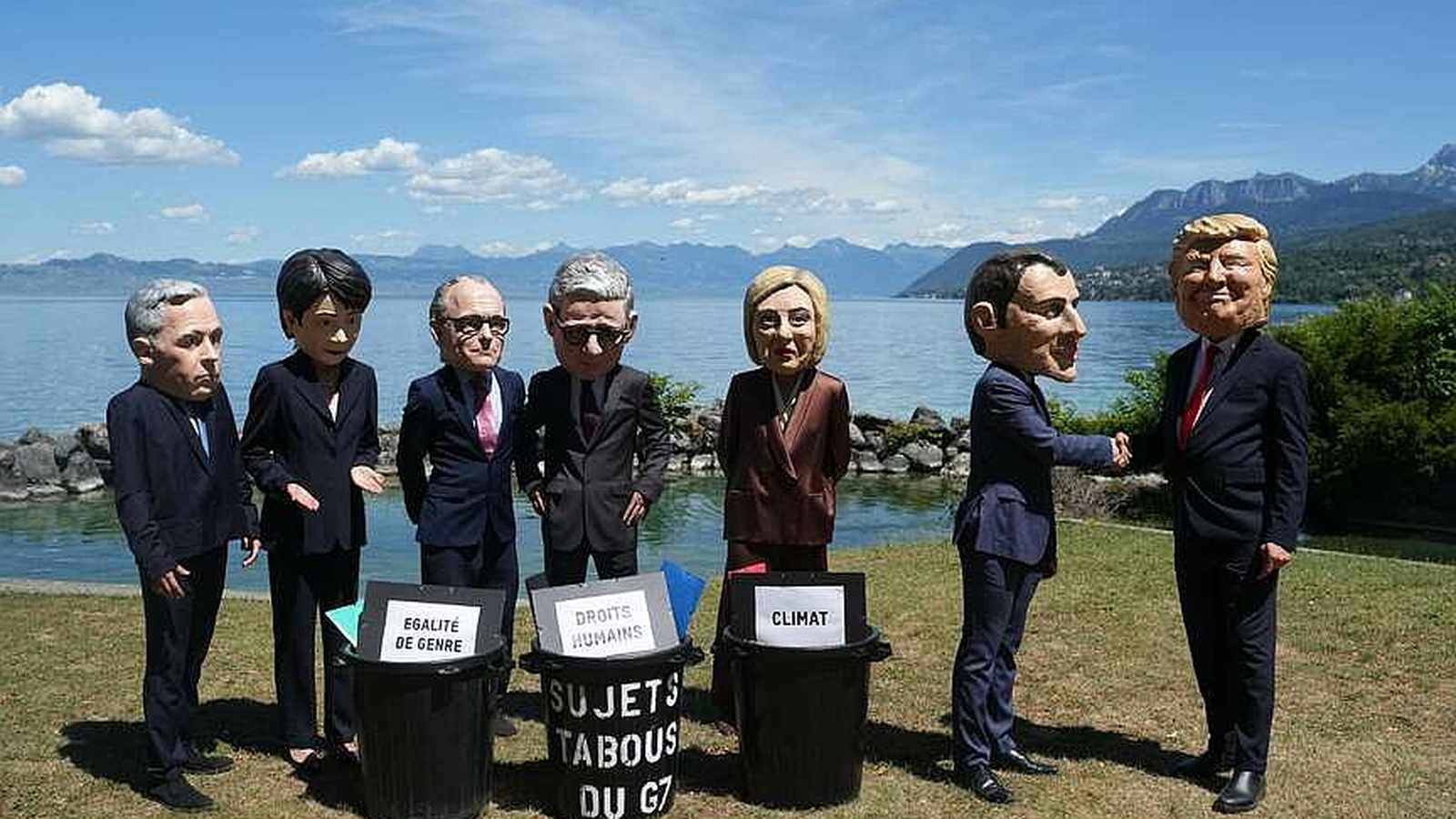 People wearing large caricature masks of world leaders standing by trash cans in Geneva