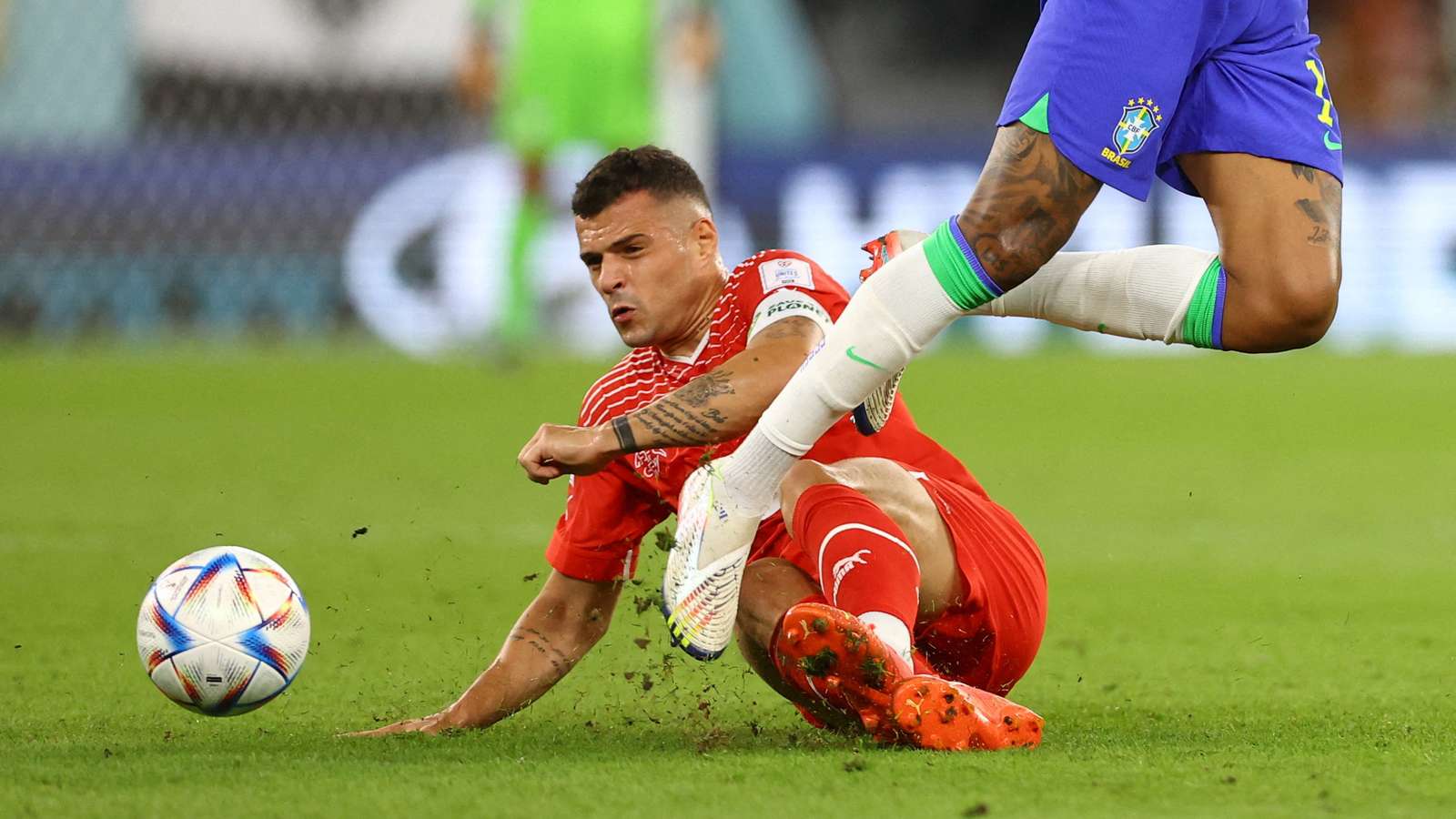 Granit Xhaka sliding to tackle for the ball during a football match
