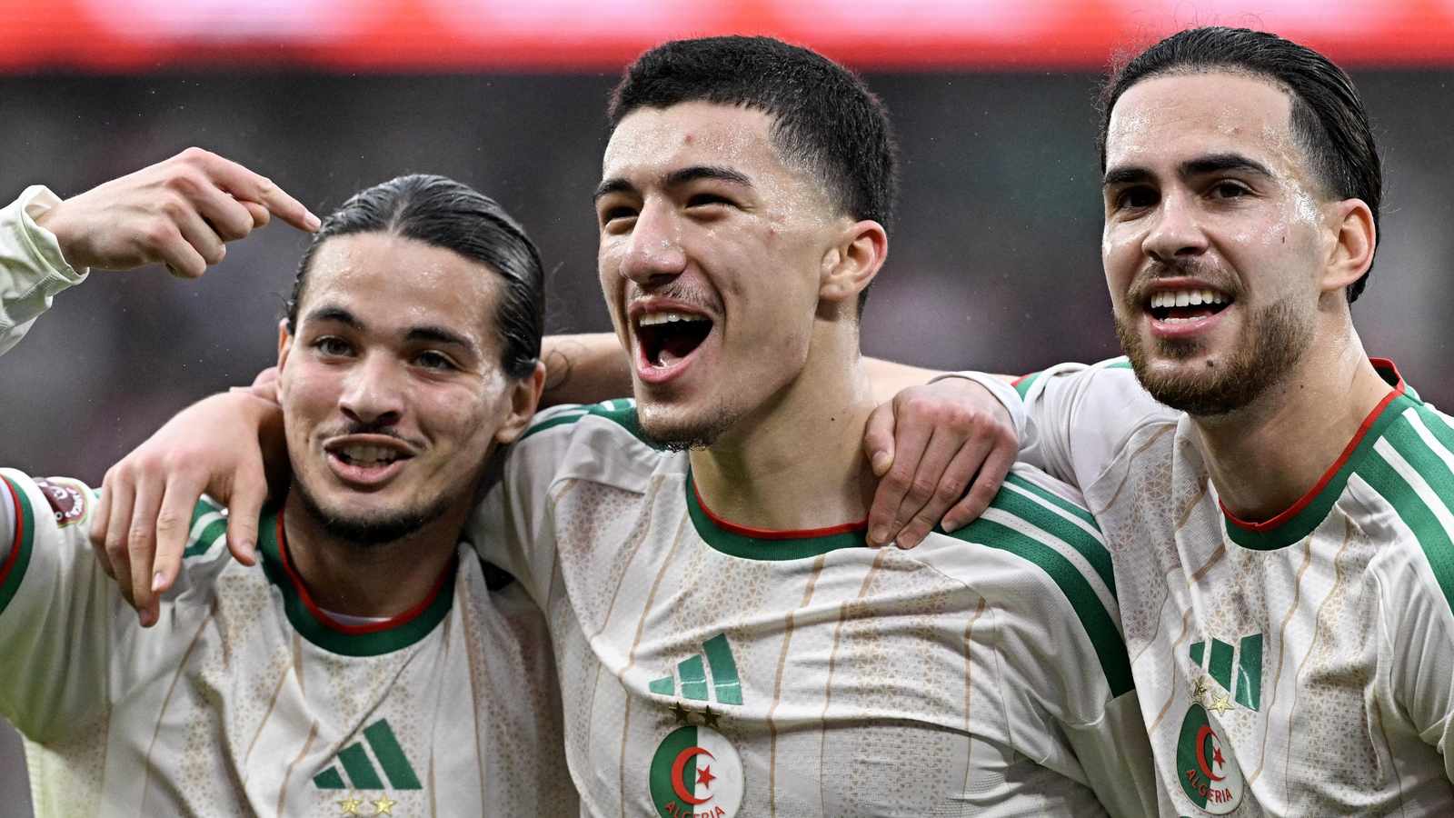 Ibrahim Maza celebrating with Algerian teammates while wearing the national team jersey