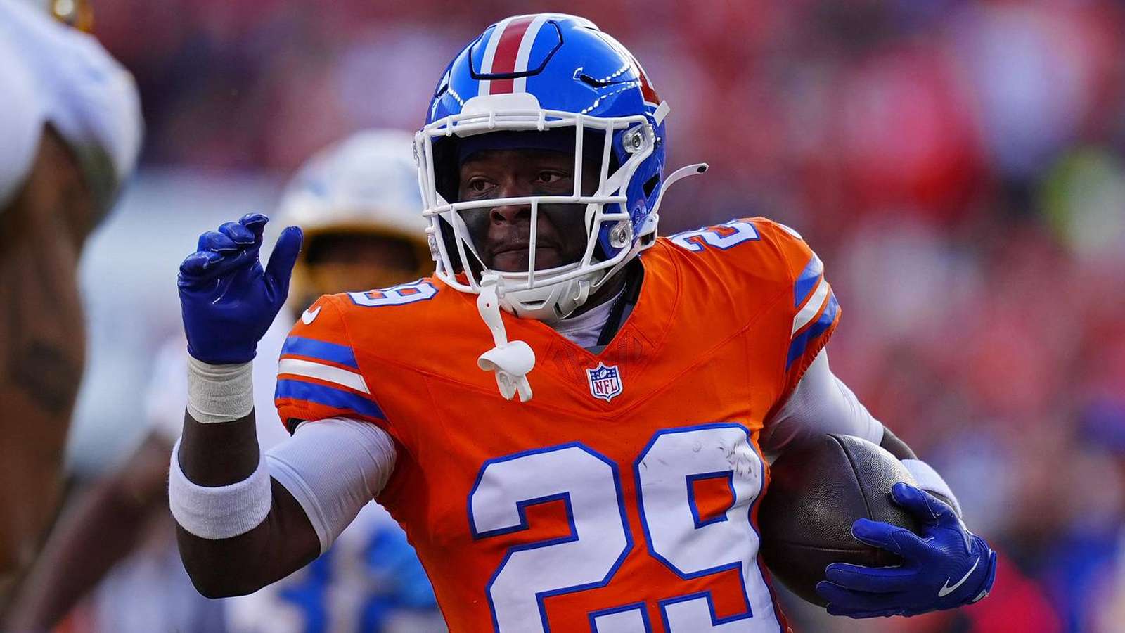 Denver Broncos cornerback JaQuan McMillian wearing his orange number 29 jersey during game
