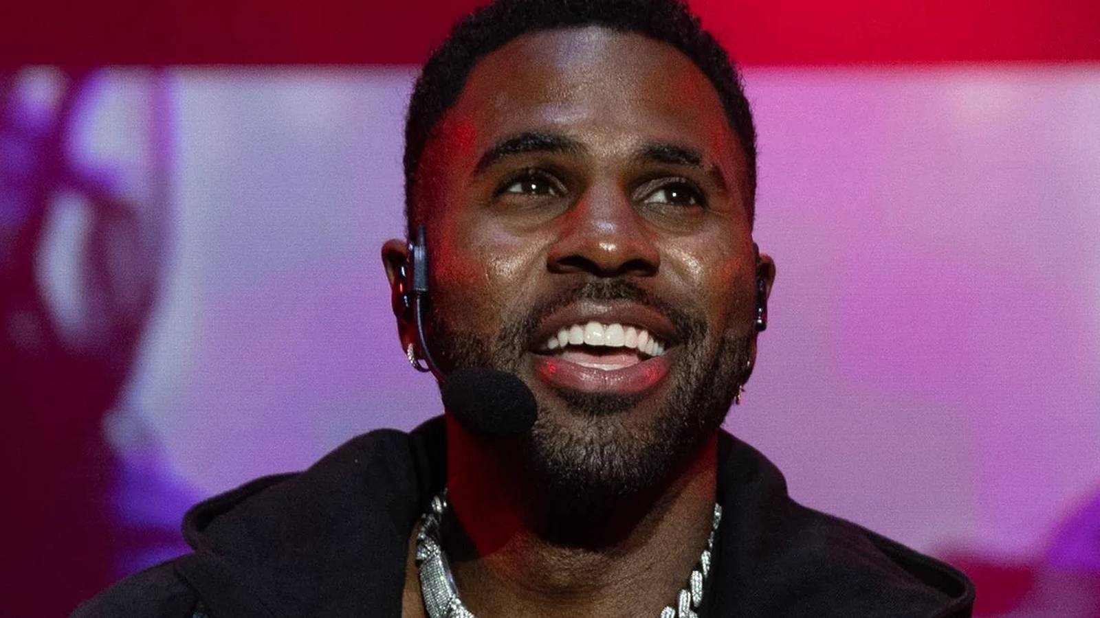 Close up portrait of singer Jason Derulo smiling while wearing a headset microphone