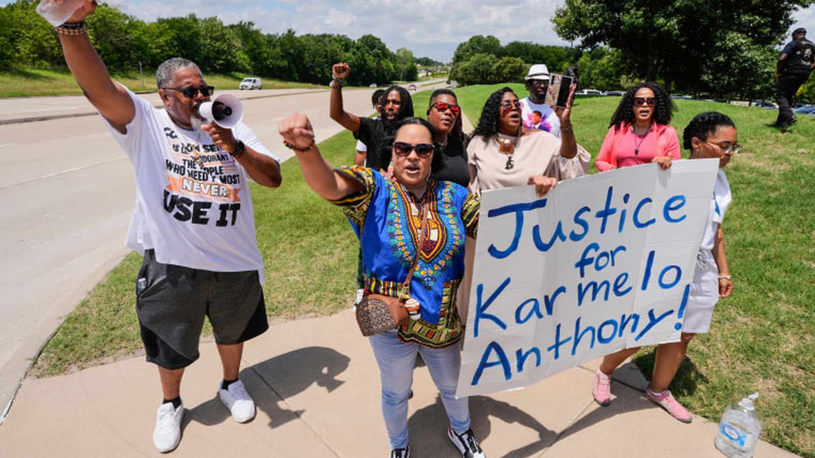 Group of protesters holding a sign that reads Justice for Karmelo Anthony outdoors