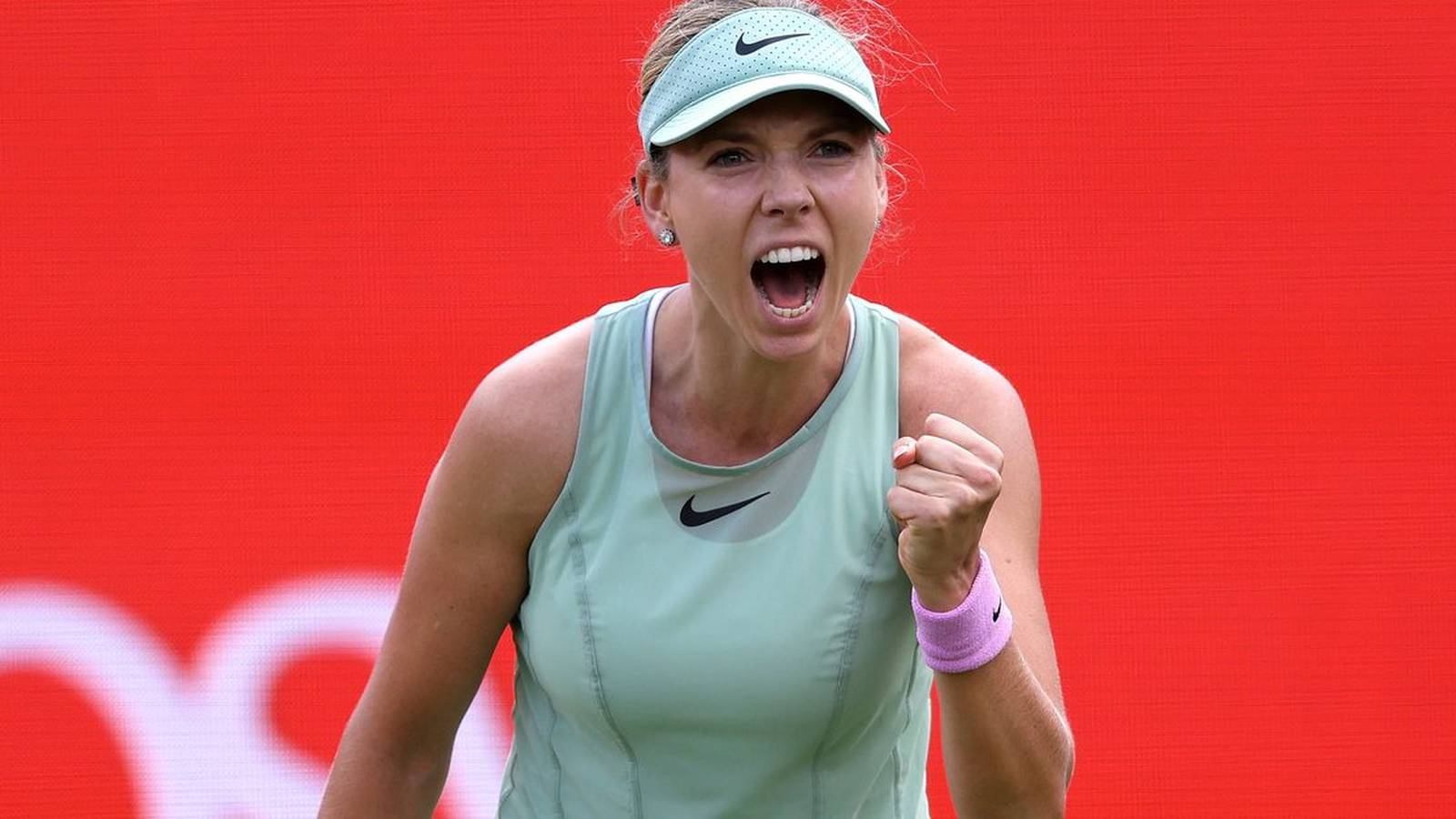 British tennis player Katie Boulter cheering and pumping her fist during a match