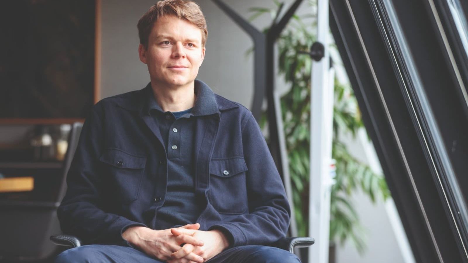 Louis Mosley, CEO of Palantir UK, sitting in an office chair looking forward