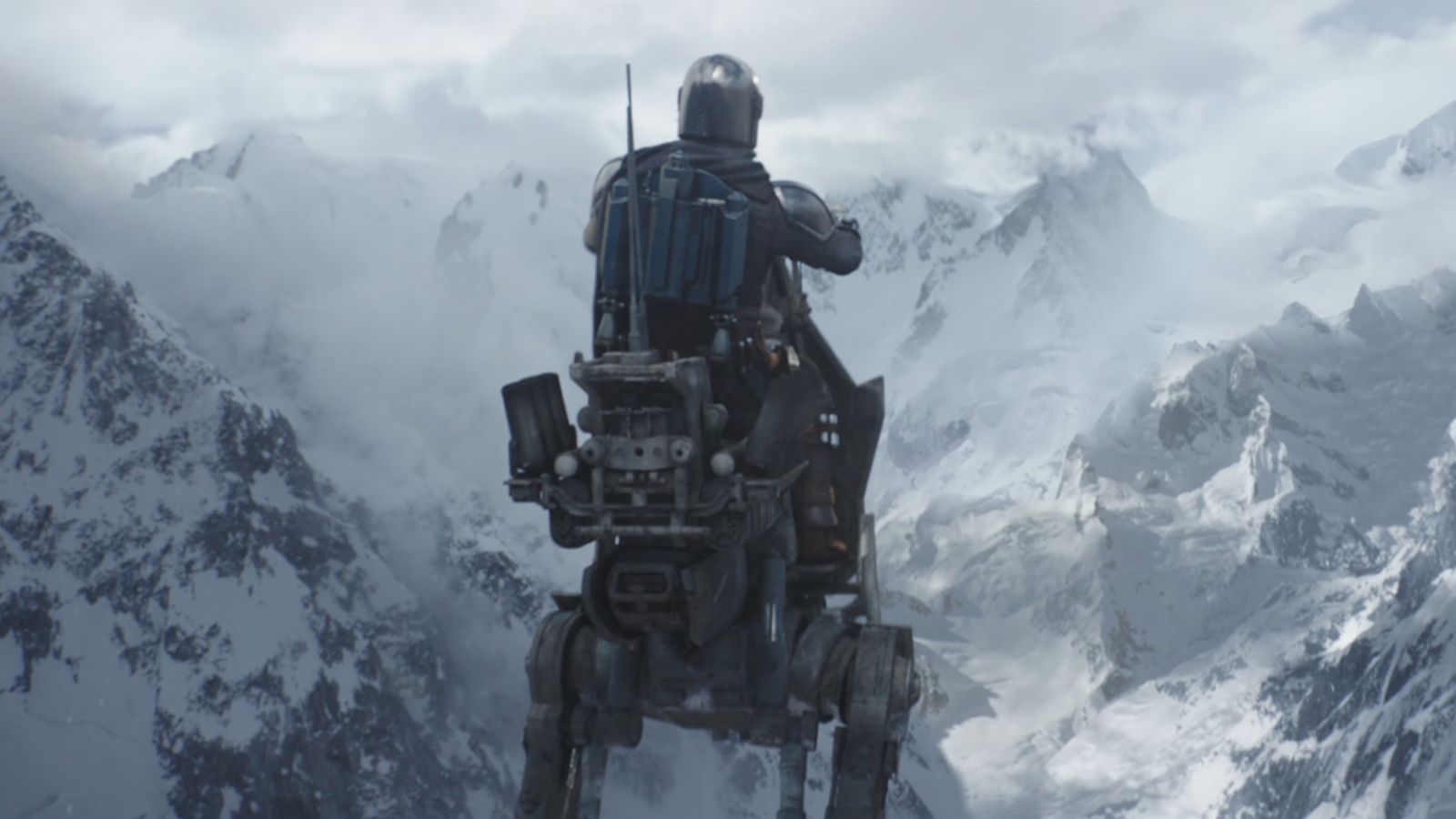 The Mandalorian riding a speeder bike through a vast snowy mountain landscape