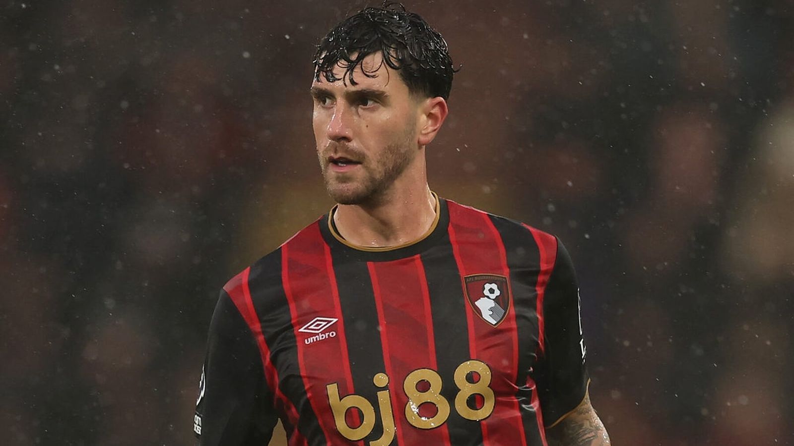 Marcos Senesi wearing the red and black striped Bournemouth football kit during a match