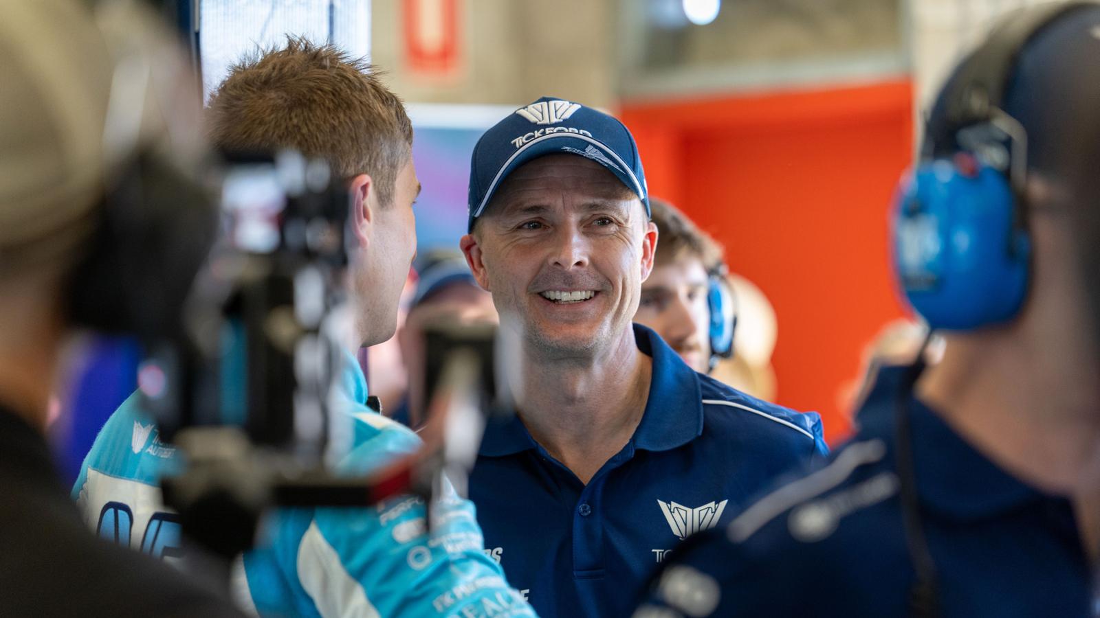 Mark Winterbottom smiling while wearing a blue team polo and baseball cap