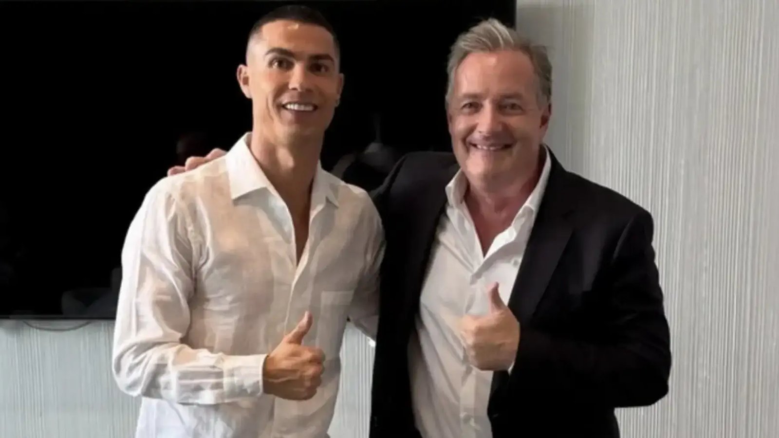 Piers Morgan and Cristiano Ronaldo smiling and giving thumbs up for a photo
