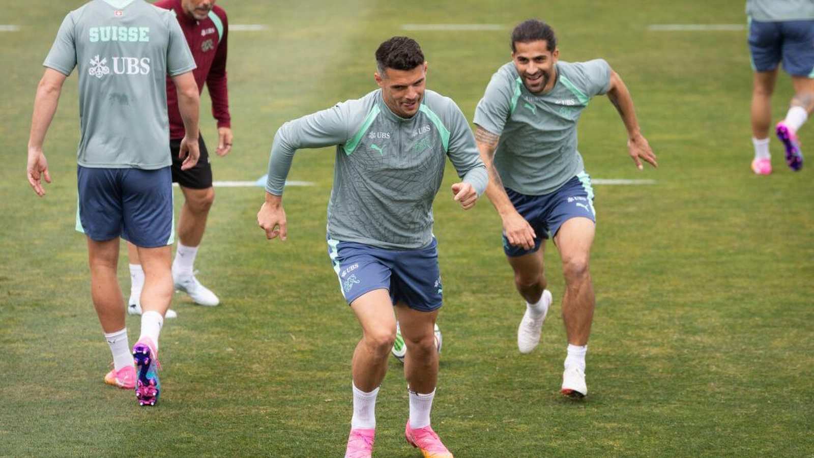 Ricardo Rodriguez and Granit Xhaka training on a soccer field in Switzerland gear