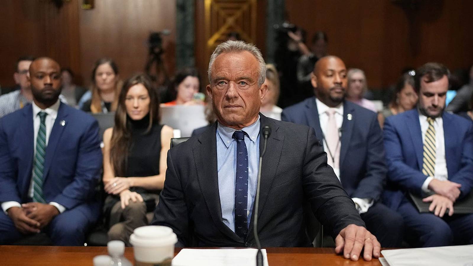Robert F Kennedy Jr sitting at a table during a formal government hearing