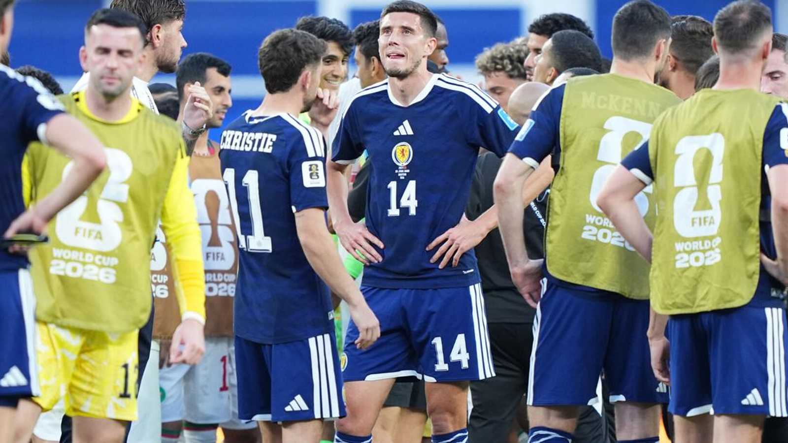 Ross Stewart standing on the pitch wearing the blue Scotland national team jersey