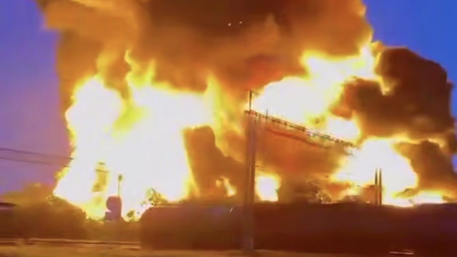 A massive fireball erupts into the sky during a nighttime drone strike explosion