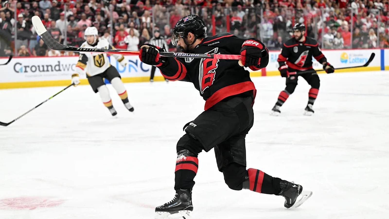 Seth Jarvis of the Carolina Hurricanes takes a powerful slapshot during a hockey game