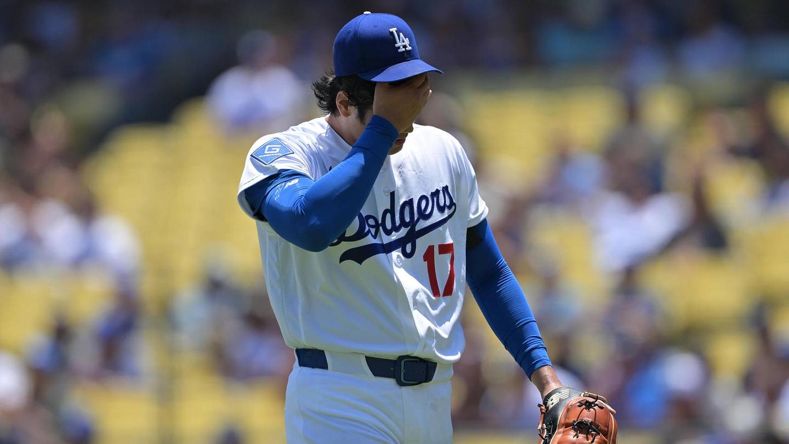 Shohei Ohtani wearing a Los Angeles Dodgers uniform looking frustrated on the field
