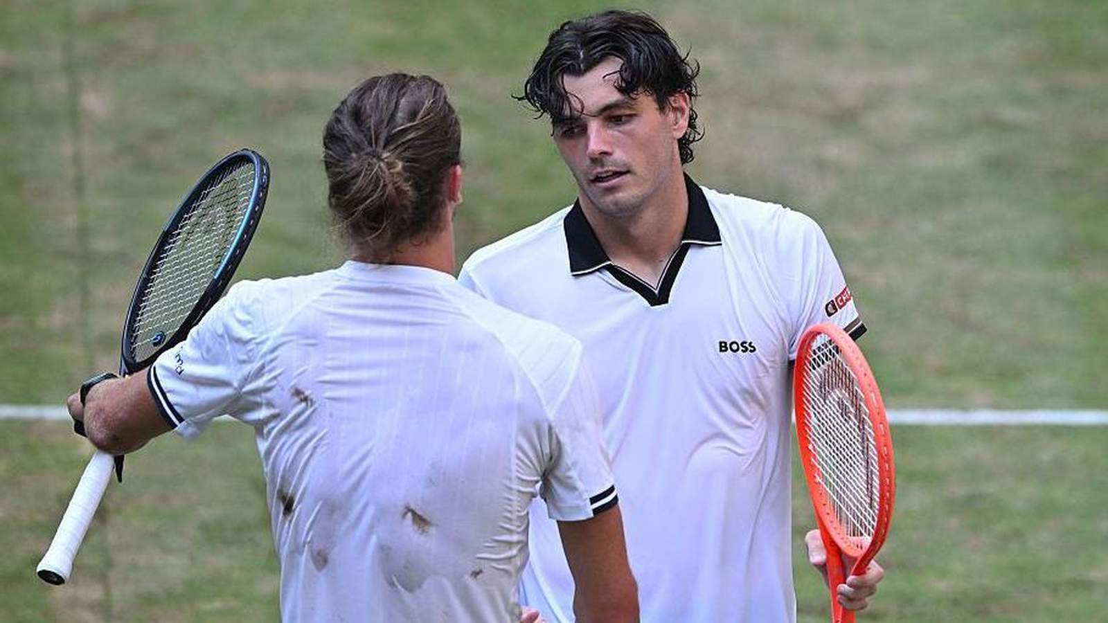 Taylor Fritz and Alexander Zverev shaking hands at the net during Halle Open
