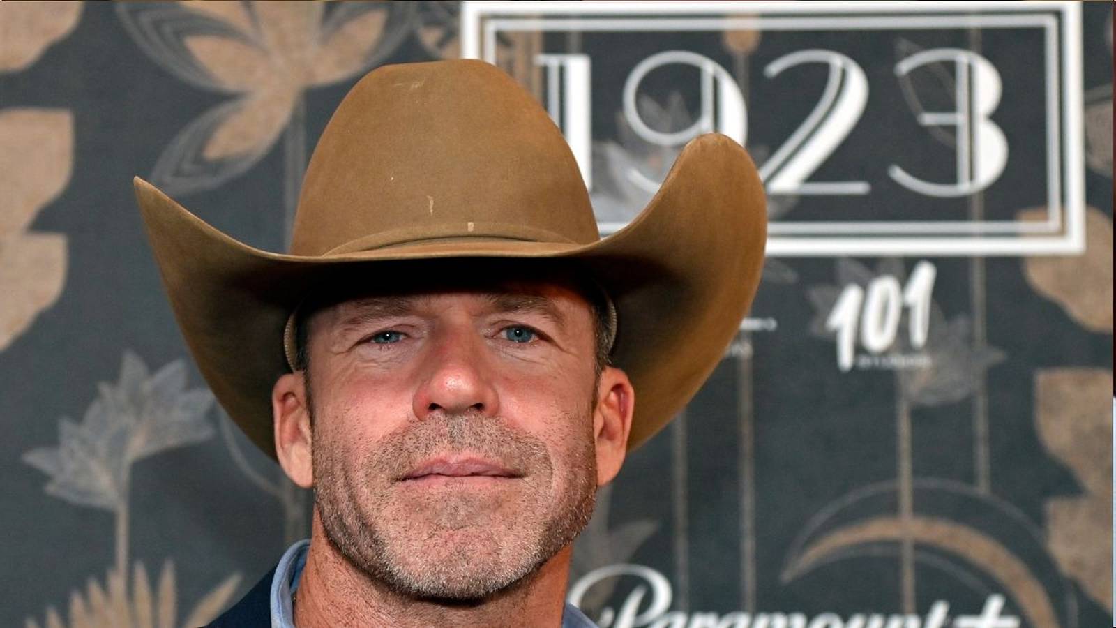 Close-up of Taylor Sheridan wearing a brown cowboy hat and looking forward
