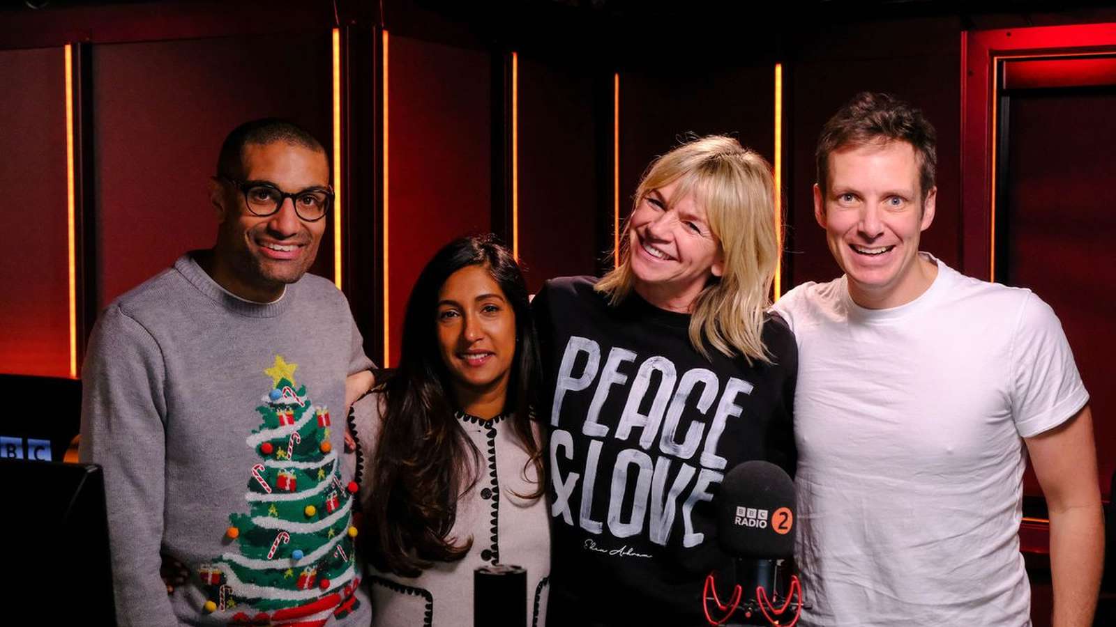 Tina Daheley posing with colleagues in the BBC Radio 2 studio setting