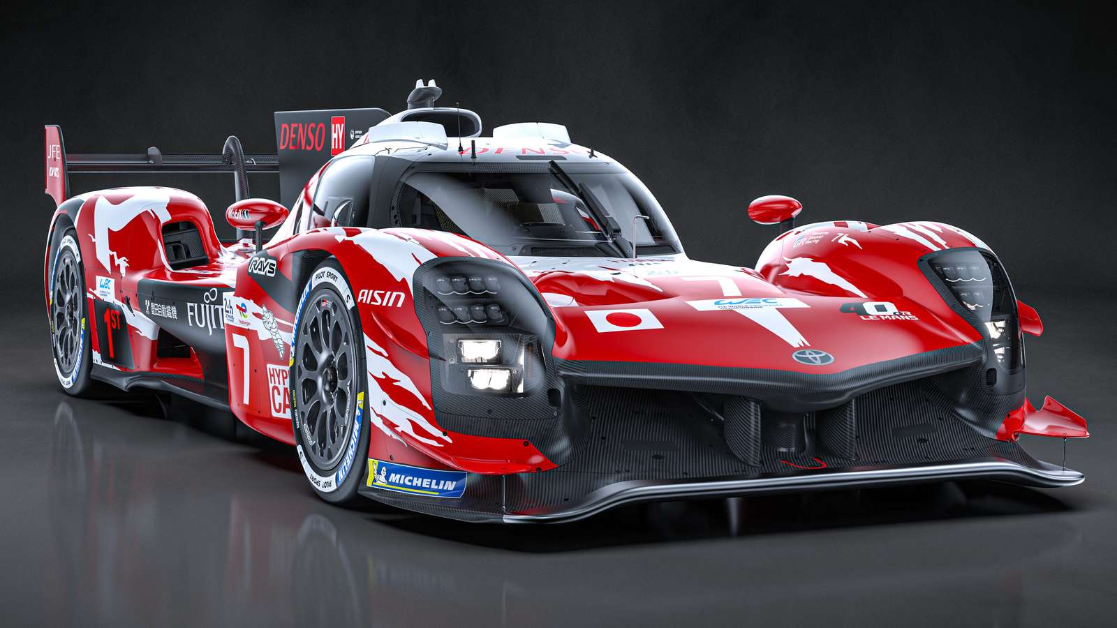 A red and white Toyota GR010 Hybrid race car studio shot on grey background