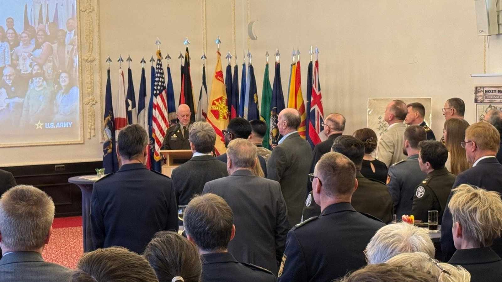 A military officer speaks at a podium before an audience of community leaders