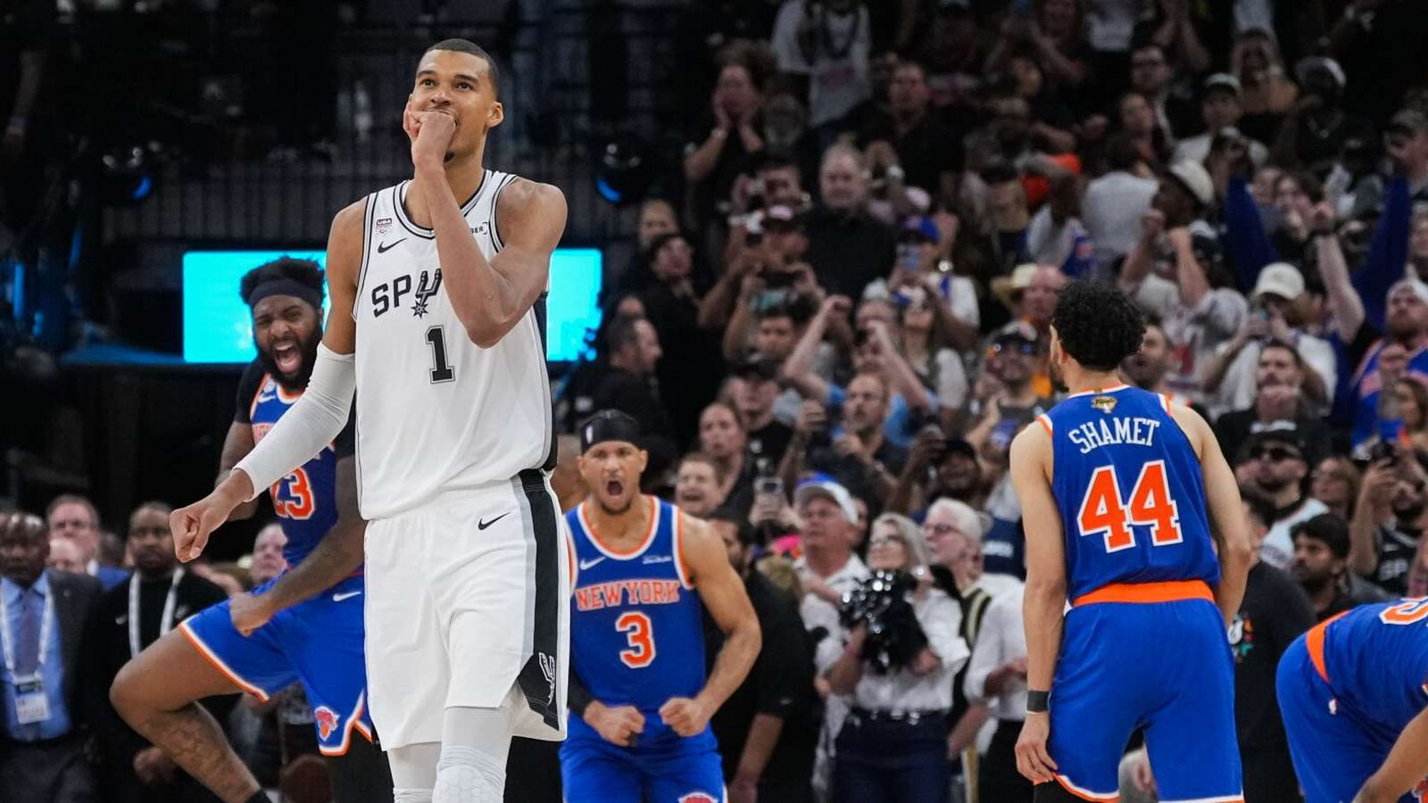 Victor Wembanyama in a Spurs jersey looking emotional on the basketball court