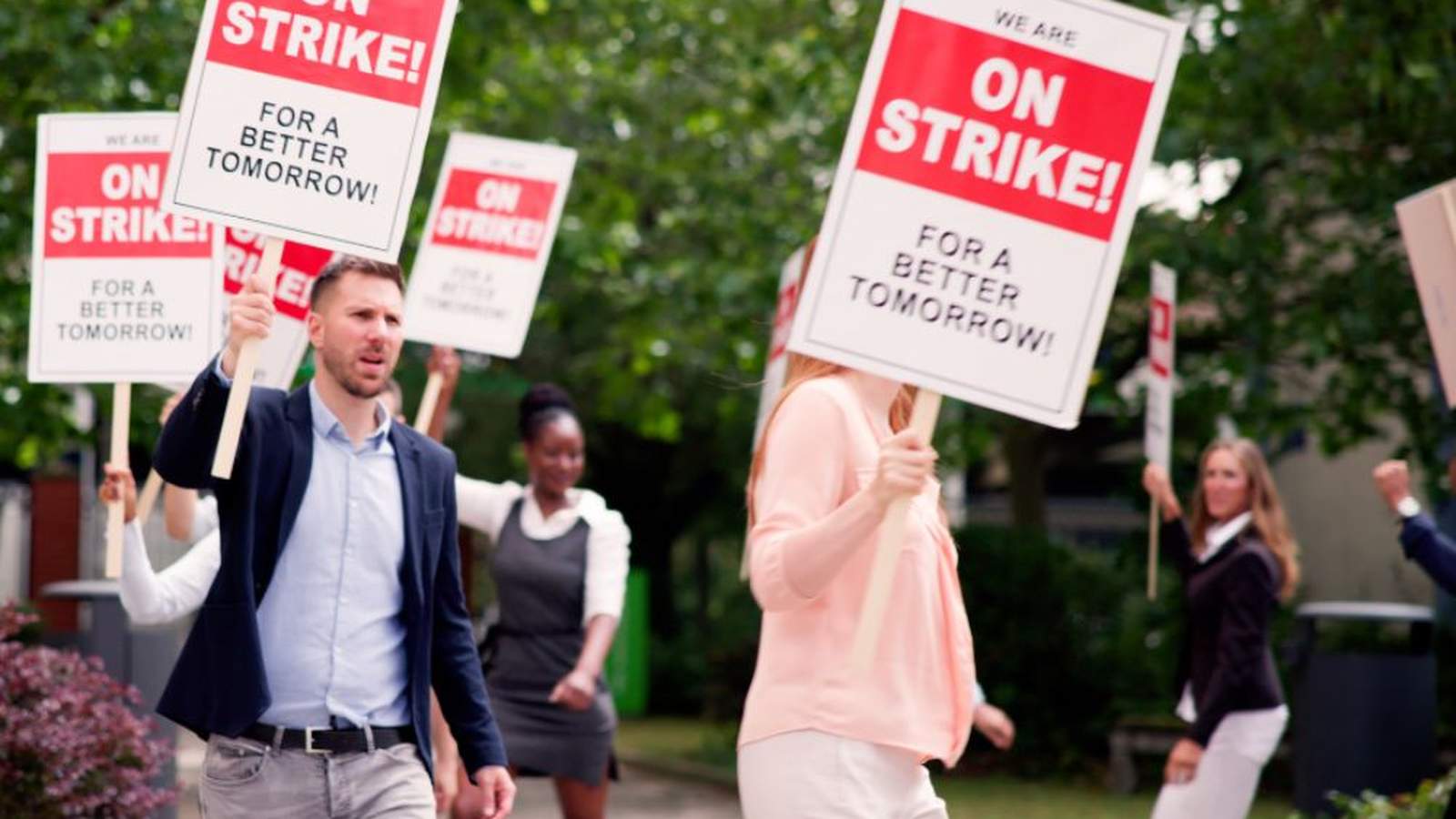 Group of teachers holding on strike signs during a public protest demonstration
